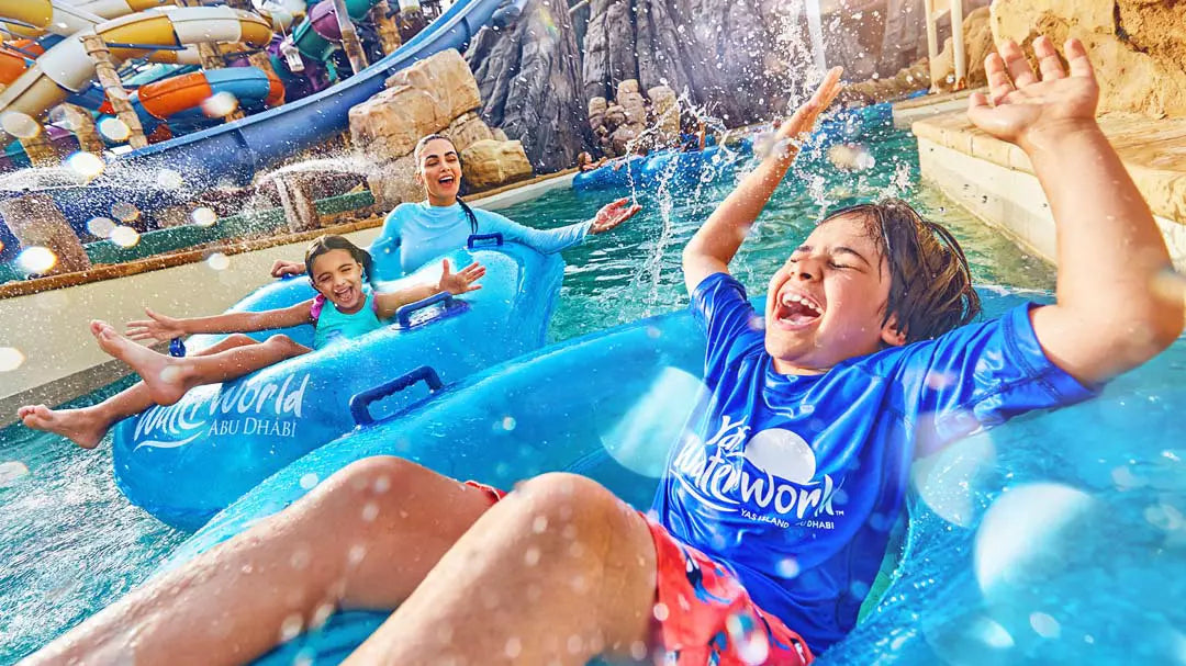 Family enjoying a water slide at Wet 'n Wild water park.
