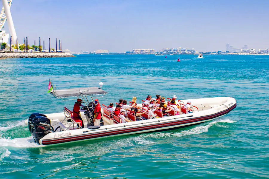 Inflatable boat with passengers on a clear blue sea, with a city skyline in the background.