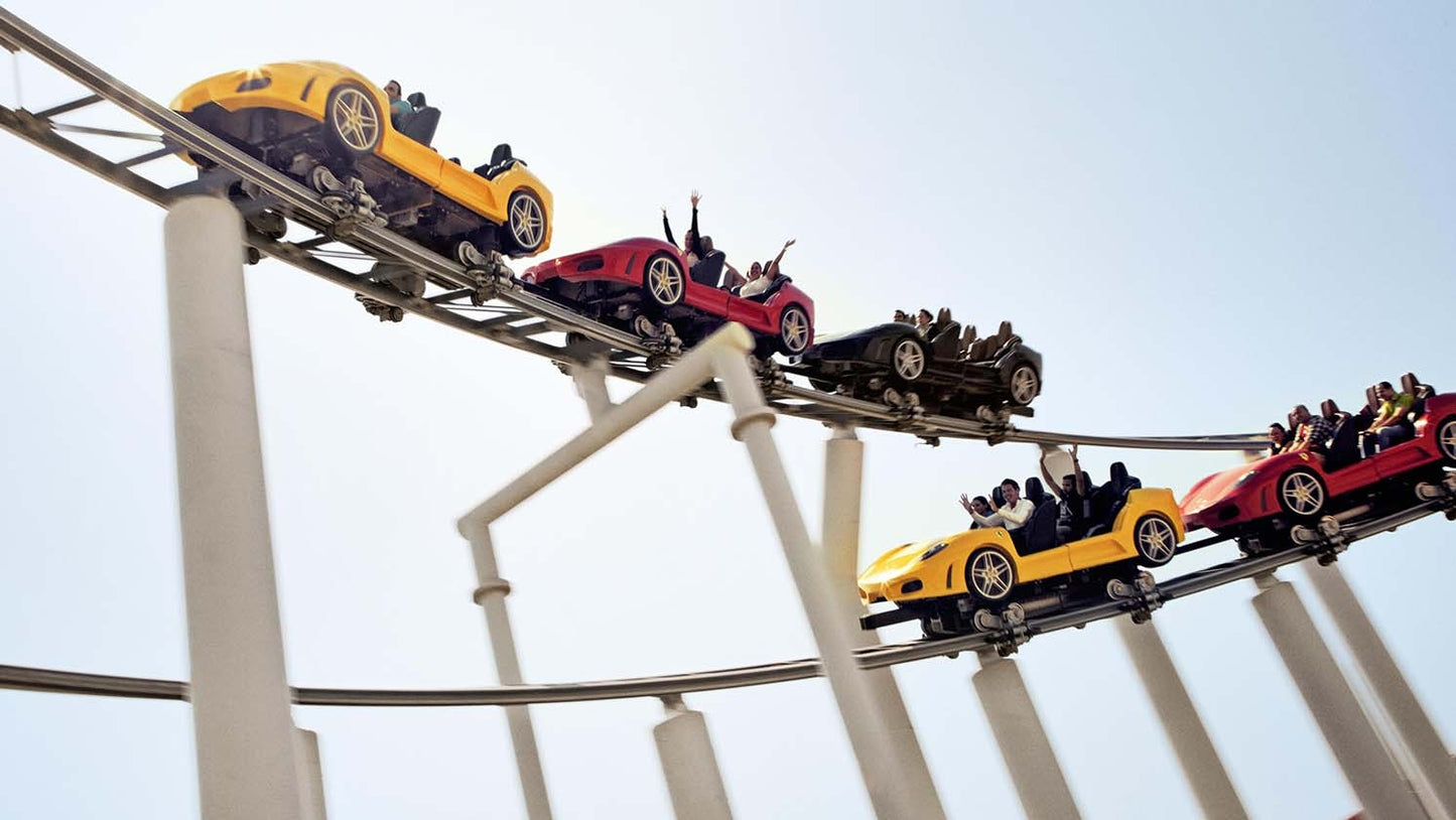 Roller coaster with colorful cars against a clear sky
