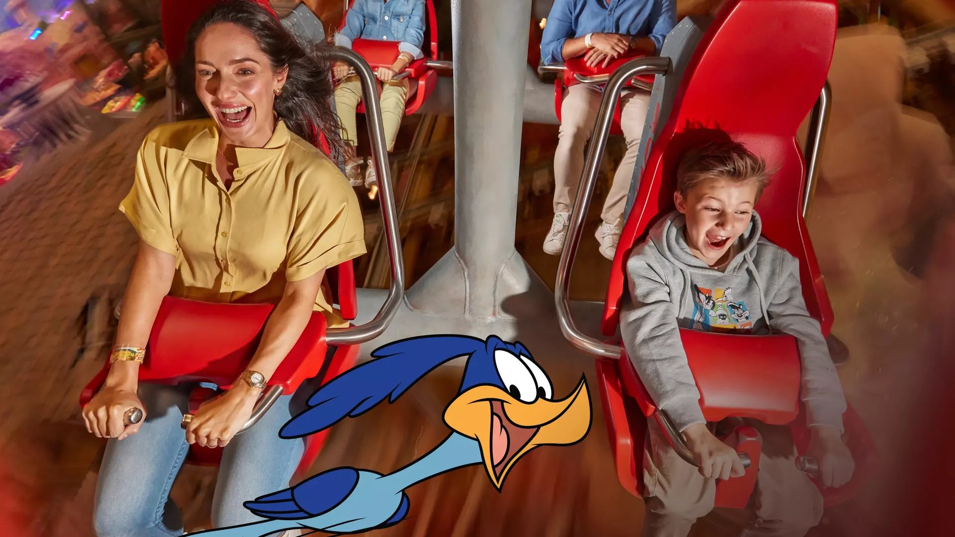 Two people on a旋转木马 with a cartoon duck character overlay.