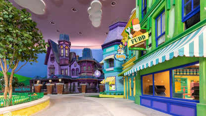 Colorful animated street scene with buildings and a clock tower.