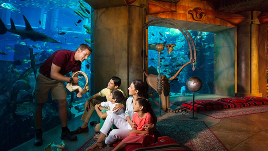 Family interacting with a shark at an aquarium