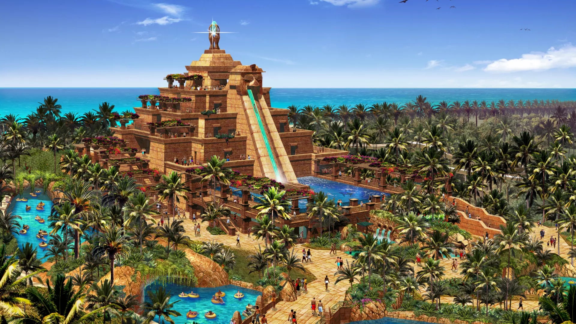 Luxury resort with a pyramid-like structure, pools, and slides surrounded by palm trees and blue sky.