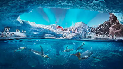Underwater scene with penguins and ice formations in a large aquarium.
