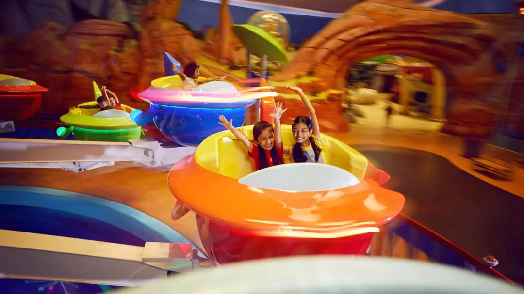 Children on a colorful amusement park ride with a vibrant background