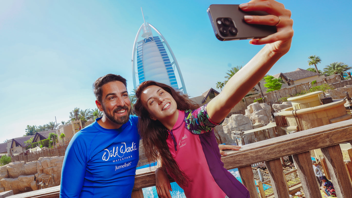 Two people taking a selfie with a famous building in the background