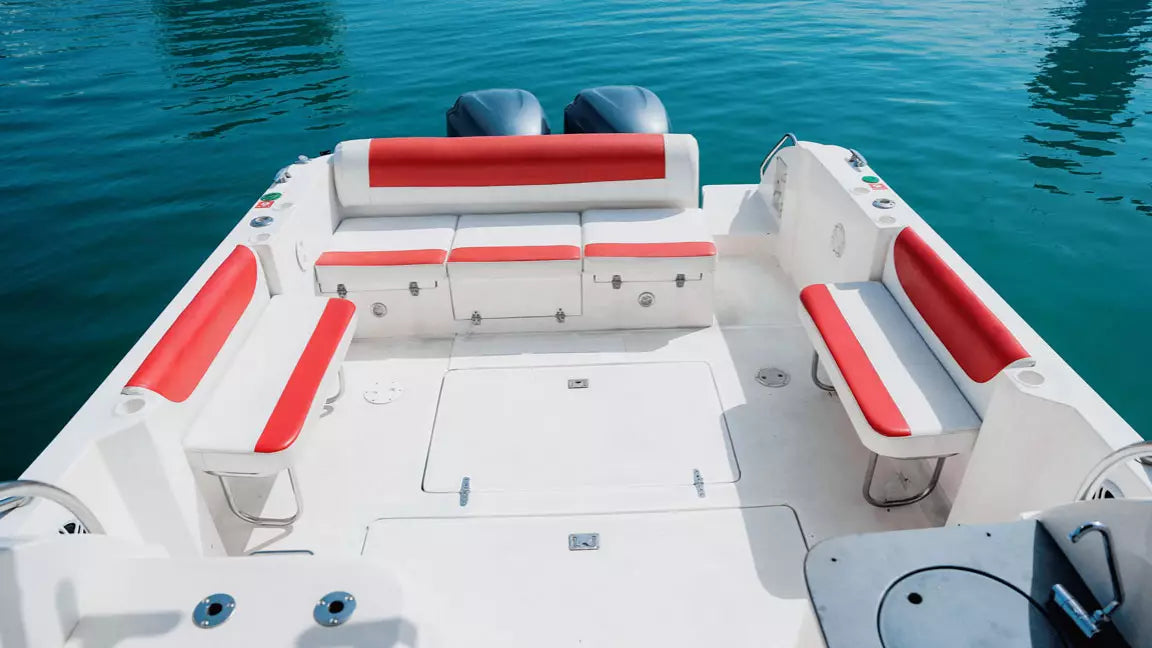 White and red boat with seats on a calm blue water background