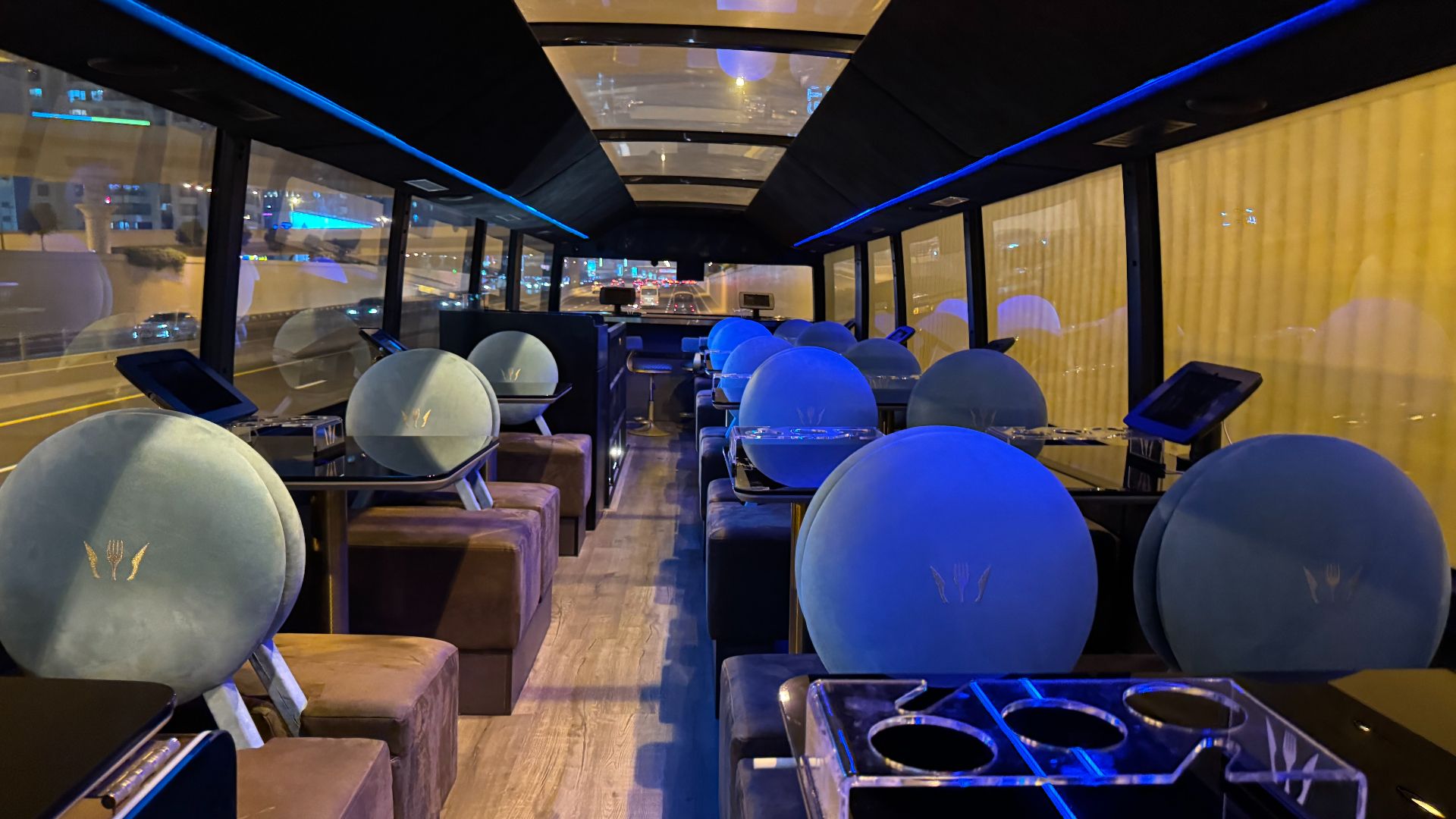 Interior of a luxury bus with plush seating and modern decor.